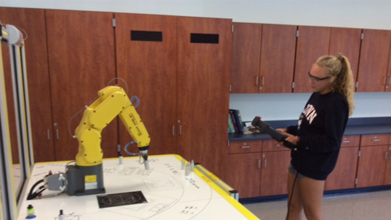 SME-PRIME---Central-Columbia---Student-operating-Fanuc-training-robot.jpg